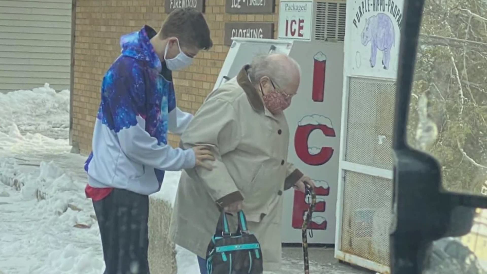 Isaiah Mcintrye, 21, had no idea someone had snapped a photo of him when he helped a 93-year-old woman walk across the ice to get to the store in Millinocket.