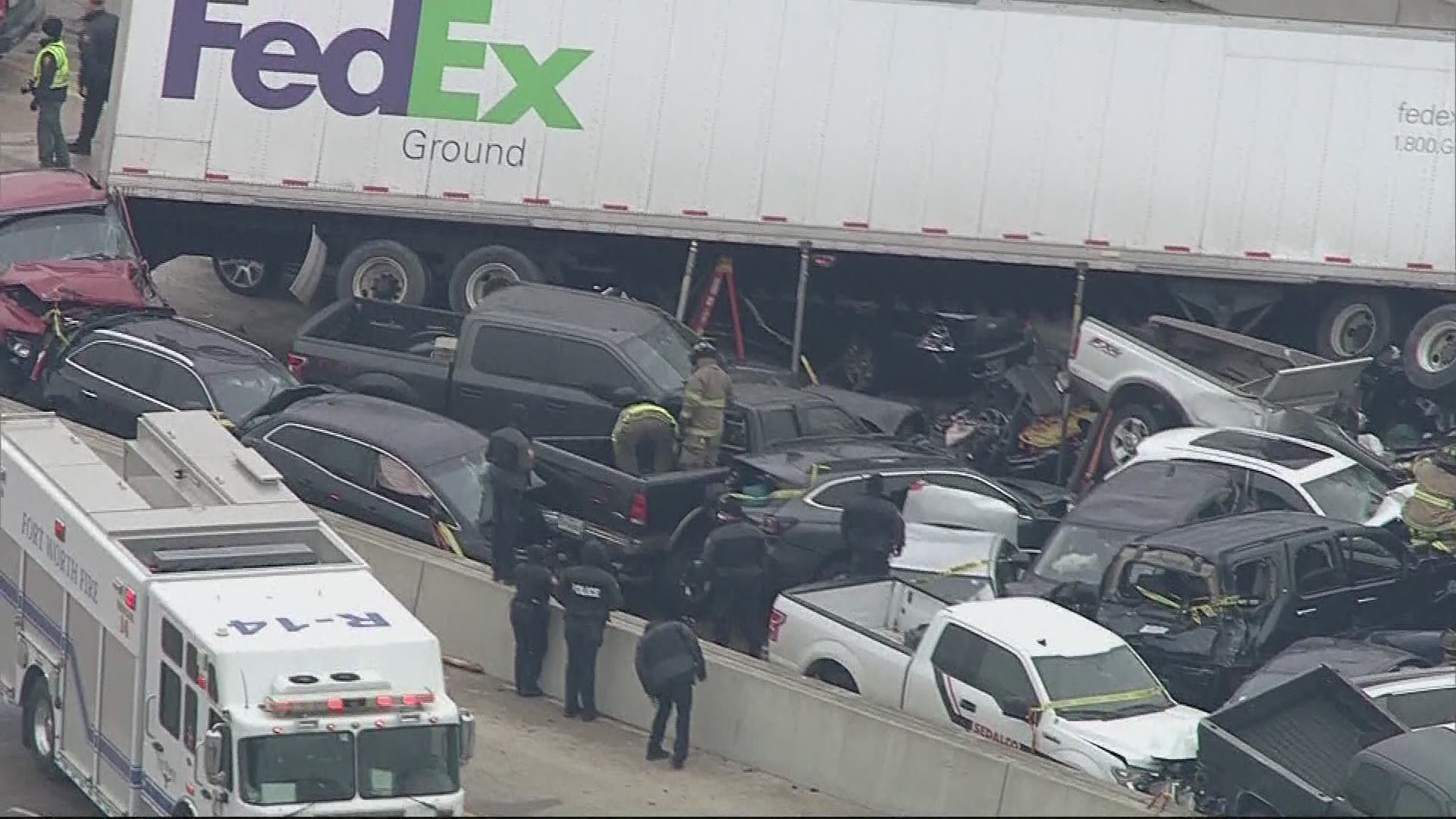 A firefighter works with the Fort Worth Police Department to rescue a dog trapped in a wrecked car involved in the I-35W accident in Fort Worth.