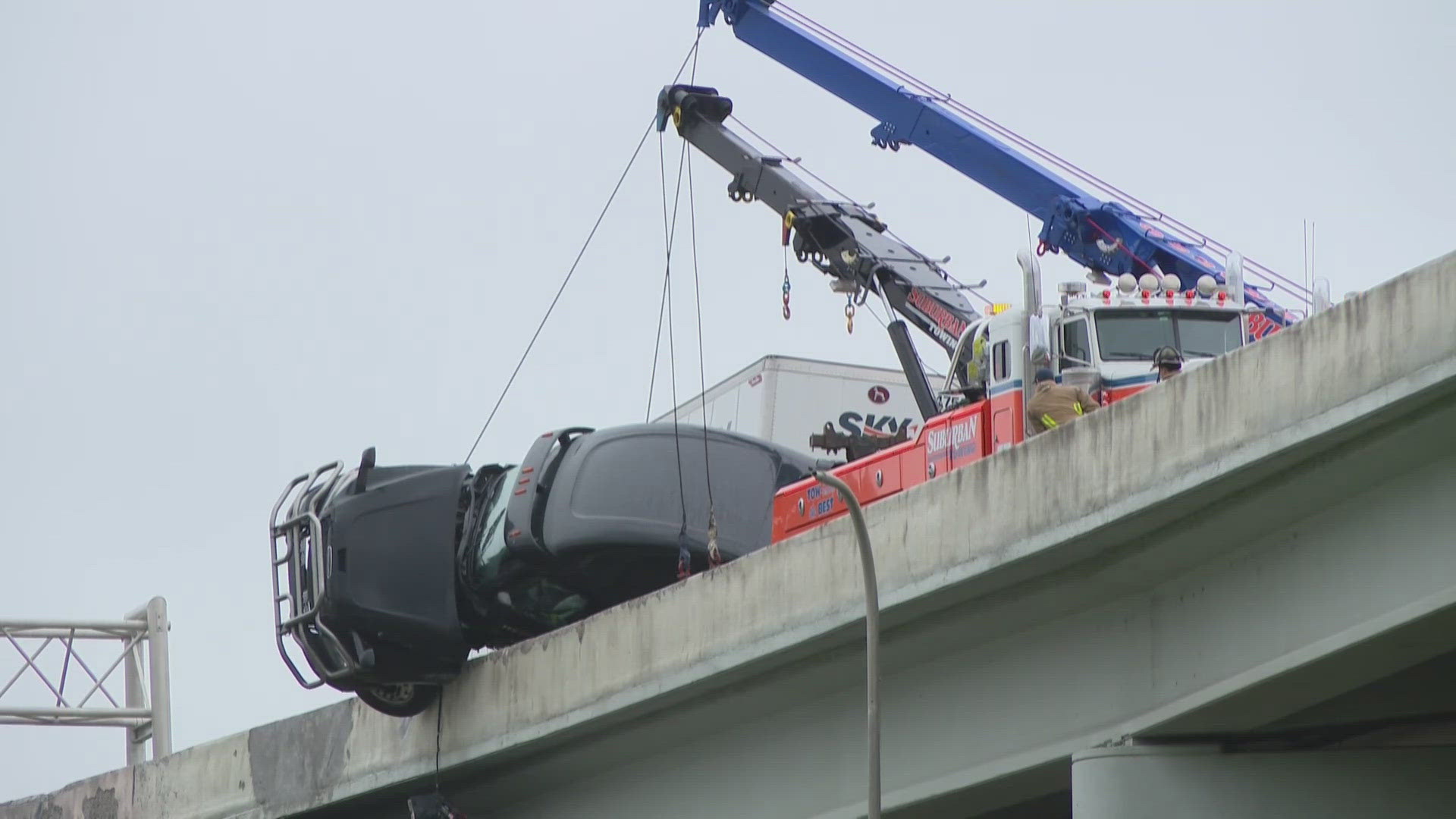 The Louisville Fire Department rescued a driver in 30 minutes after a semi cab dangled from the Kennedy Bridge following a single-vehicle crash.