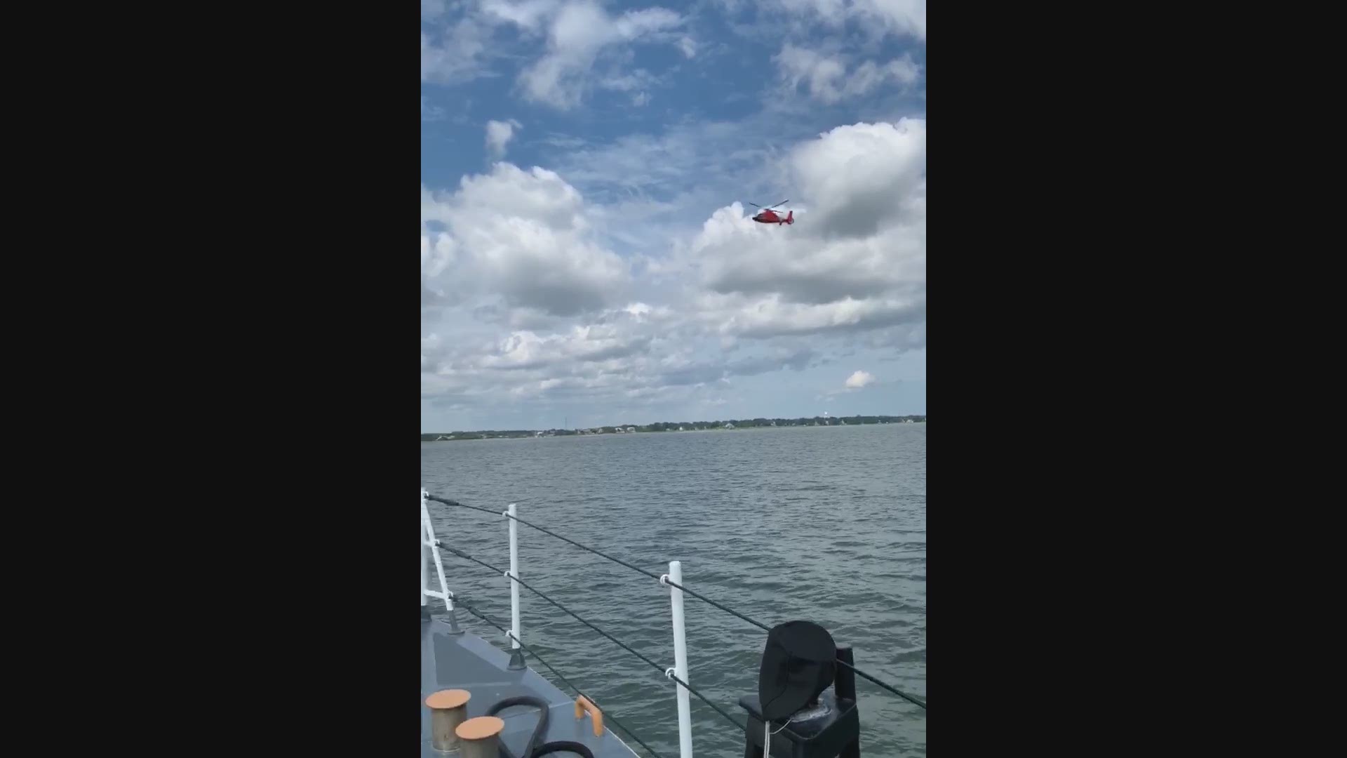 The Coast Guard Cutter Cormorant and an Air Facility Charleston MH-65 Dolphin helicopter search for a missing boater in the Charleston Harbor July 25, 2019.