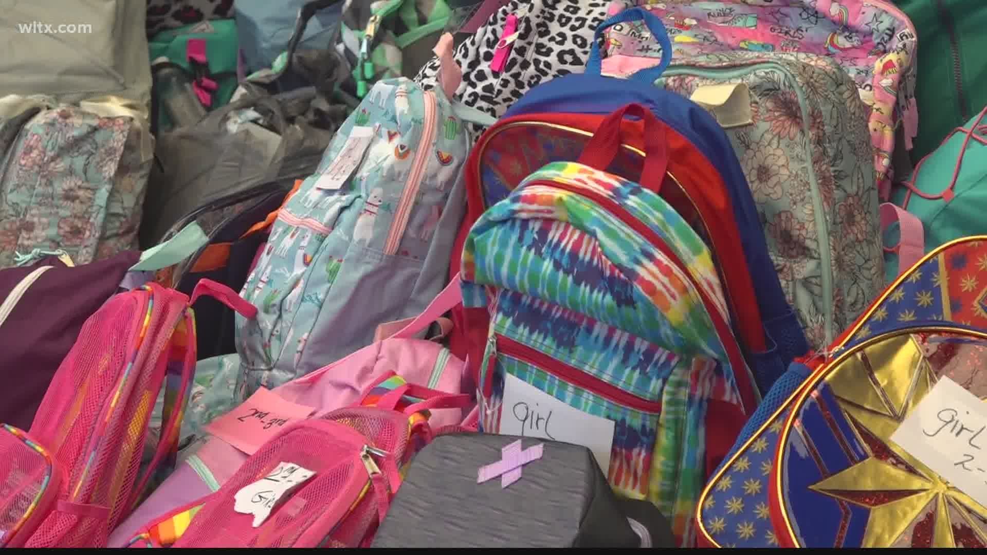 Hundreds of donated backpacks given to school children