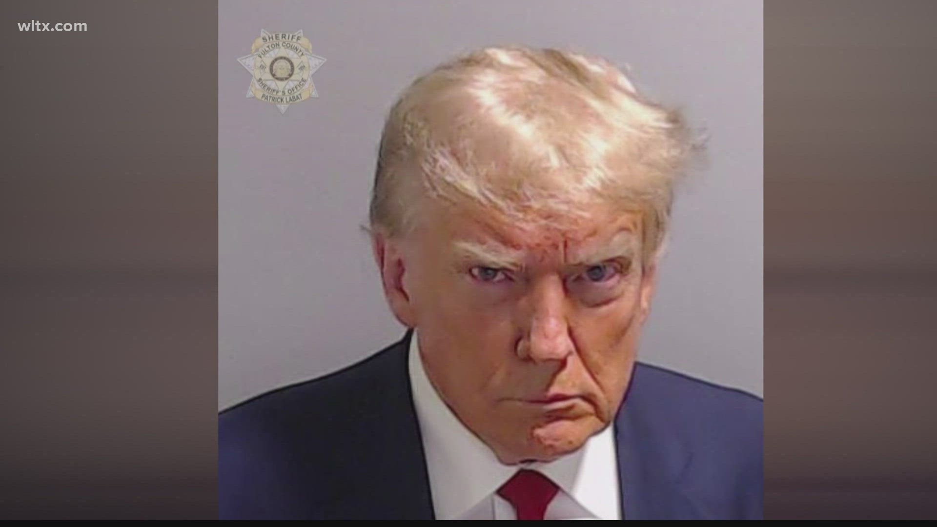 It was a brisk 20-minute booking that yielded a historic first: a mug shot of a U.S. ex-president.
