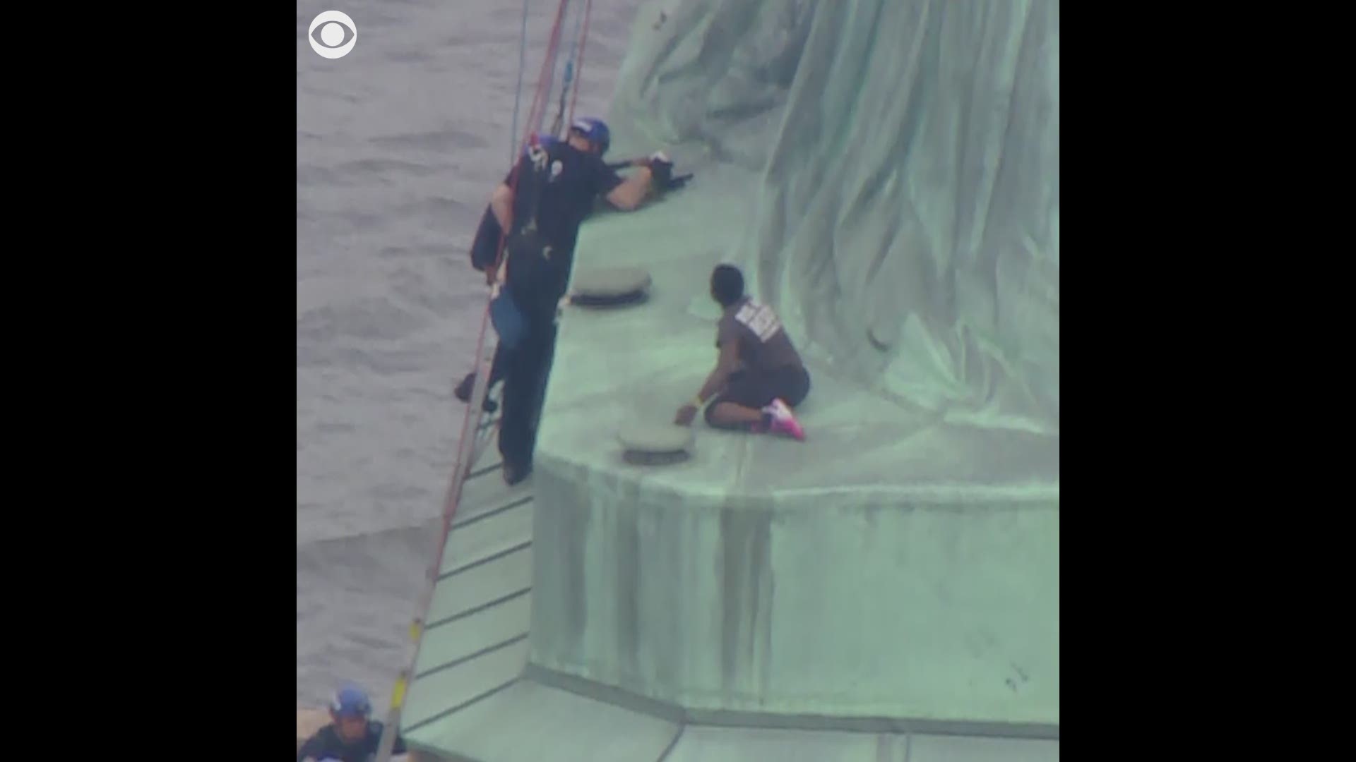 A protester who climbed the Statue of Liberty's base was escorted down by police after a roughly four-hour standoff that forced the evacuation of Liberty Island on the Fourth of July.