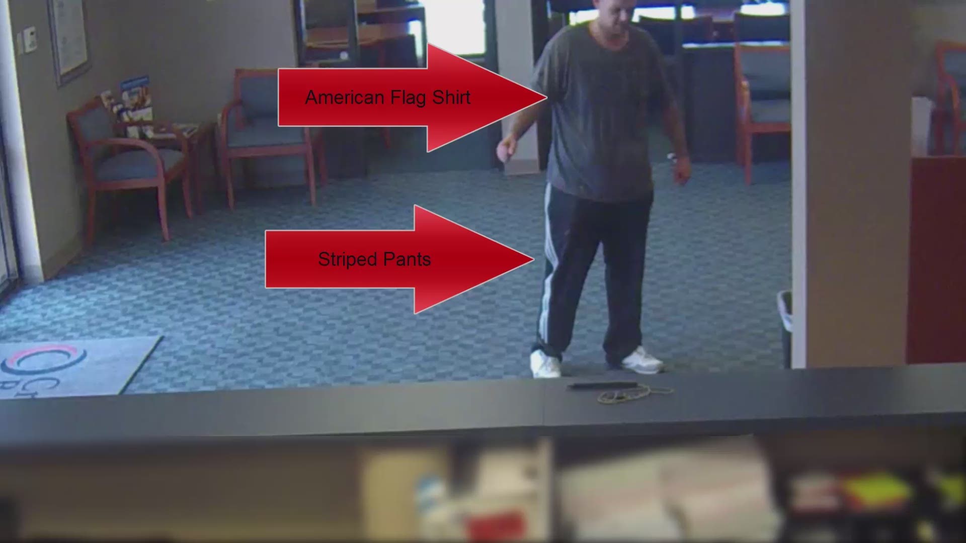Surveillance video shows the suspect wearing an American flag shirt and striped pants with several tattoos.