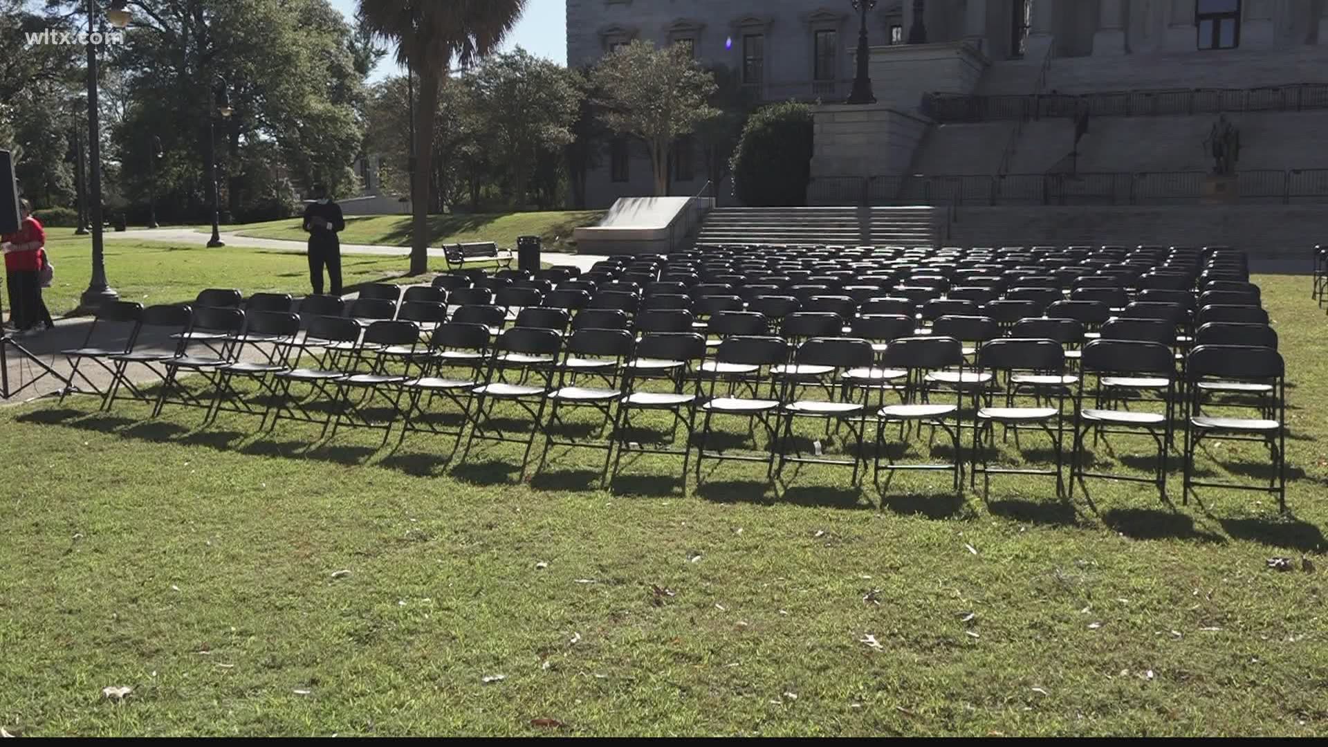 In the middle of the lawn there were 384 chairs to represent the 3,840 people who have passed away from COVID-19 in the state.