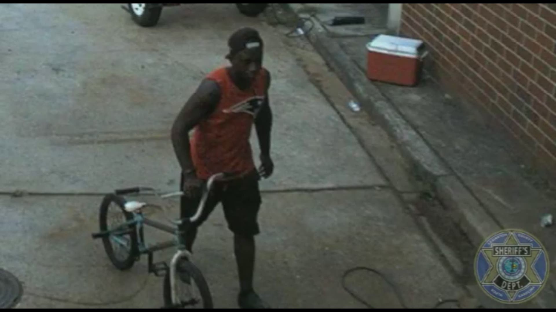 In surveillance video, a man can be seen riding his bike and stopping at Red Bank Elementary School on July 26.