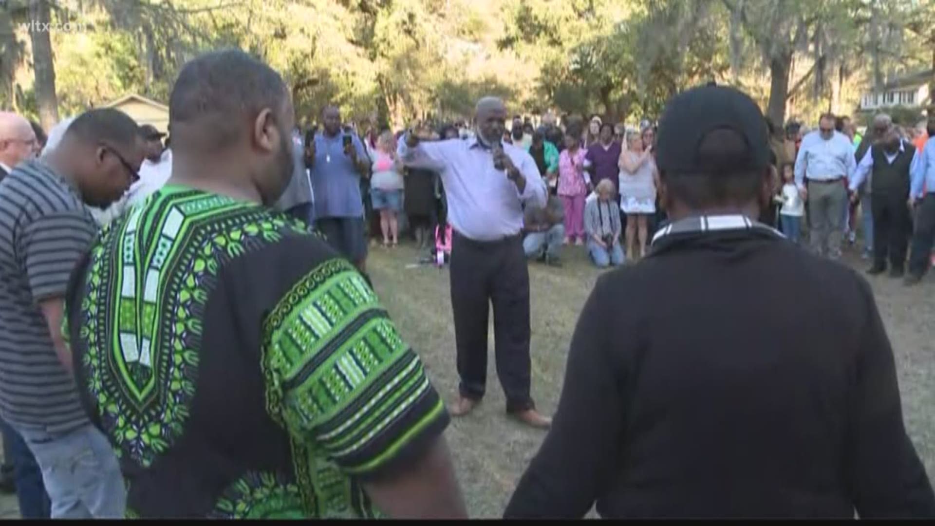 Close to 100 people filled a park in Walterboro Thursday night for a prayer vigil.