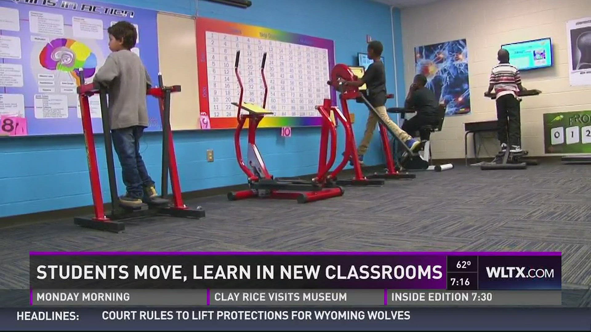 Students move in classroom complete with bike desks.