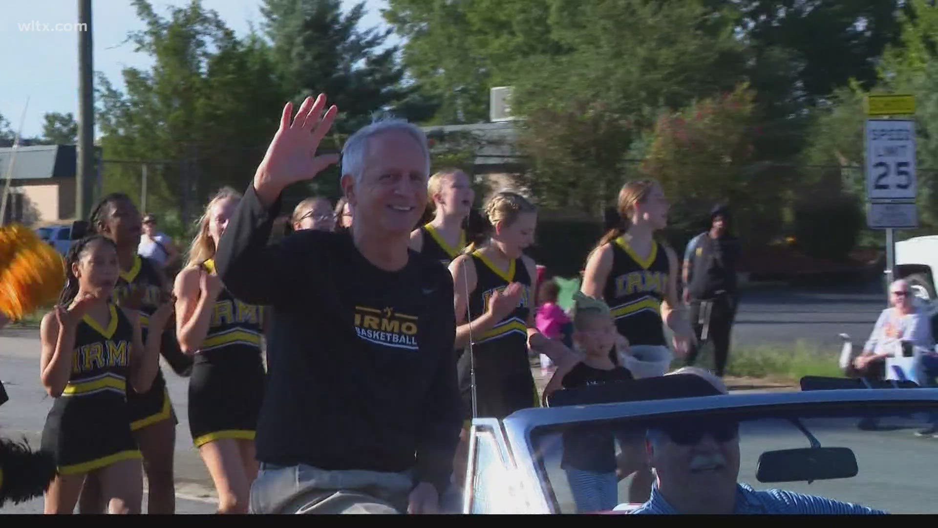 Irmo head boys basketball coach Tim Whipple spent his Saturday morning riding down St. Andrews in a convertible as part of his duties as Okra Strut Grand Marshal.
