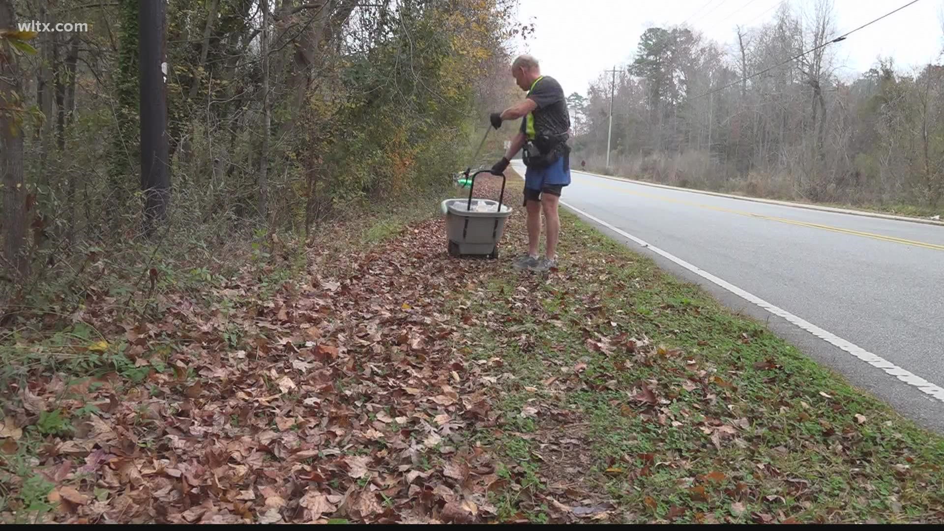 Fred McGrew picks up trash along Gills Creek Parkway in south Columbia, South Carolina