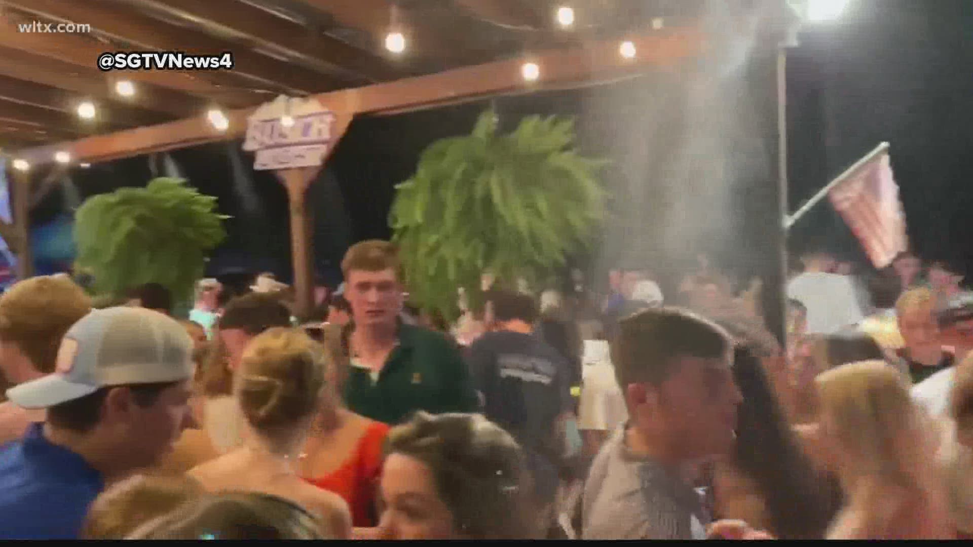 Videos of dozens of young people crowding at a Columbia bar are circulating on social media