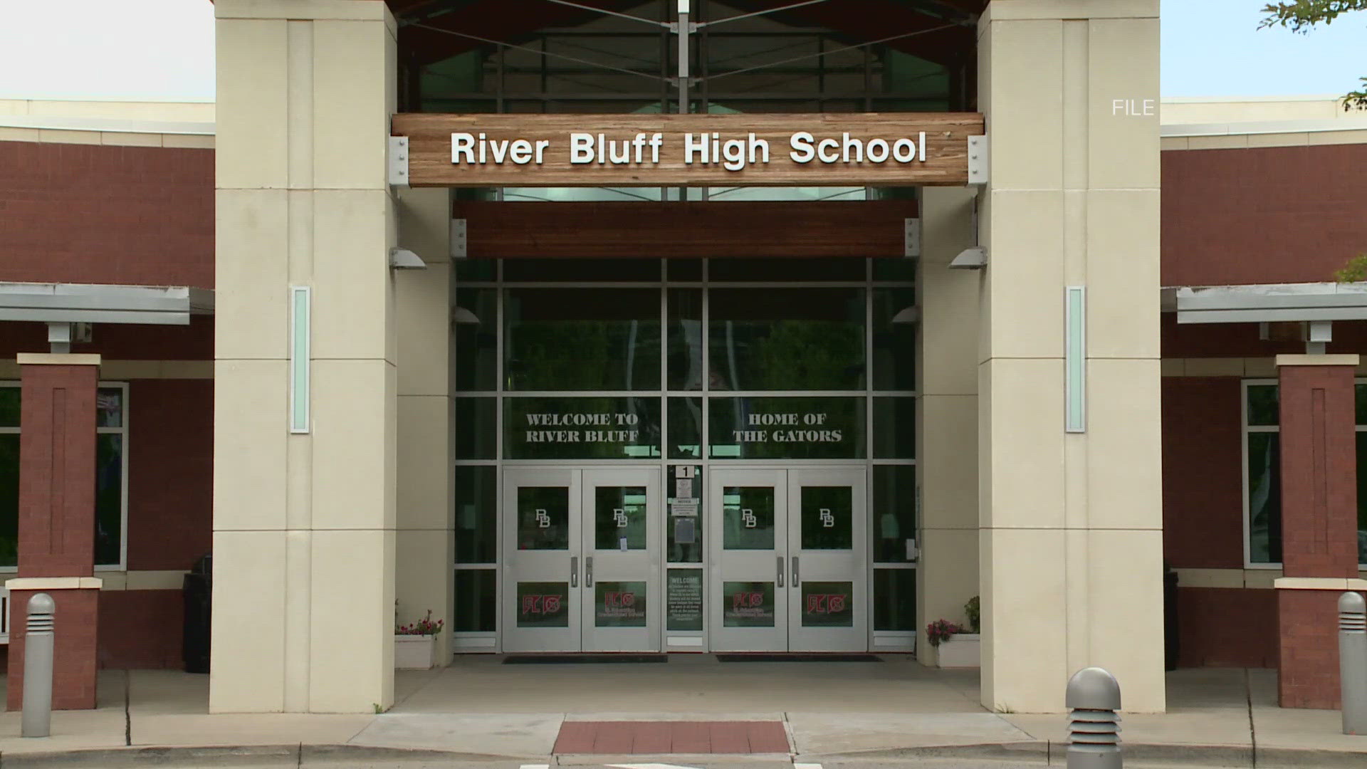 The woman was arrested Wednesday after police said she went into River Bluff High School and threatened an employee Wednesday.