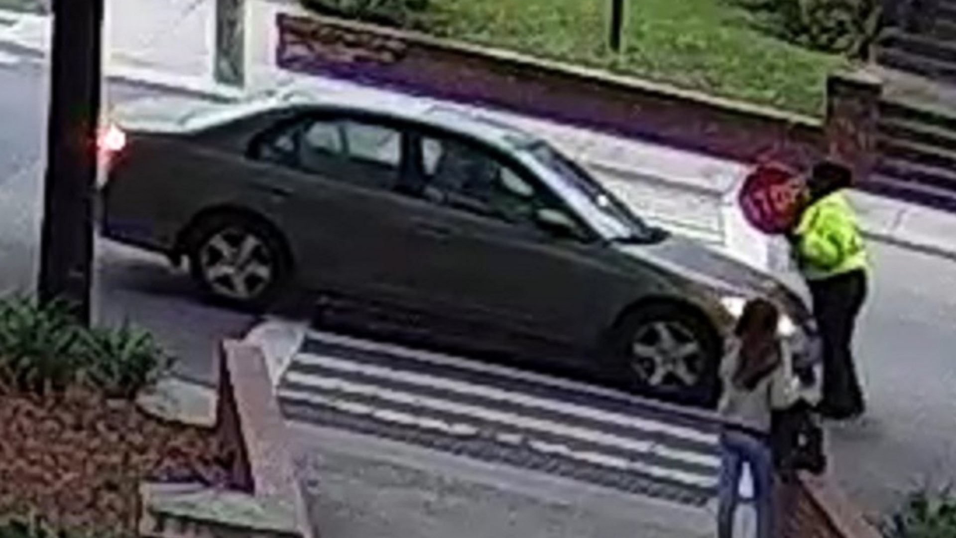 In the video, you can see the Charleston crossing guard trying to stop the car. The car keeps pushing against the guard until it finally pushes her out of the way.