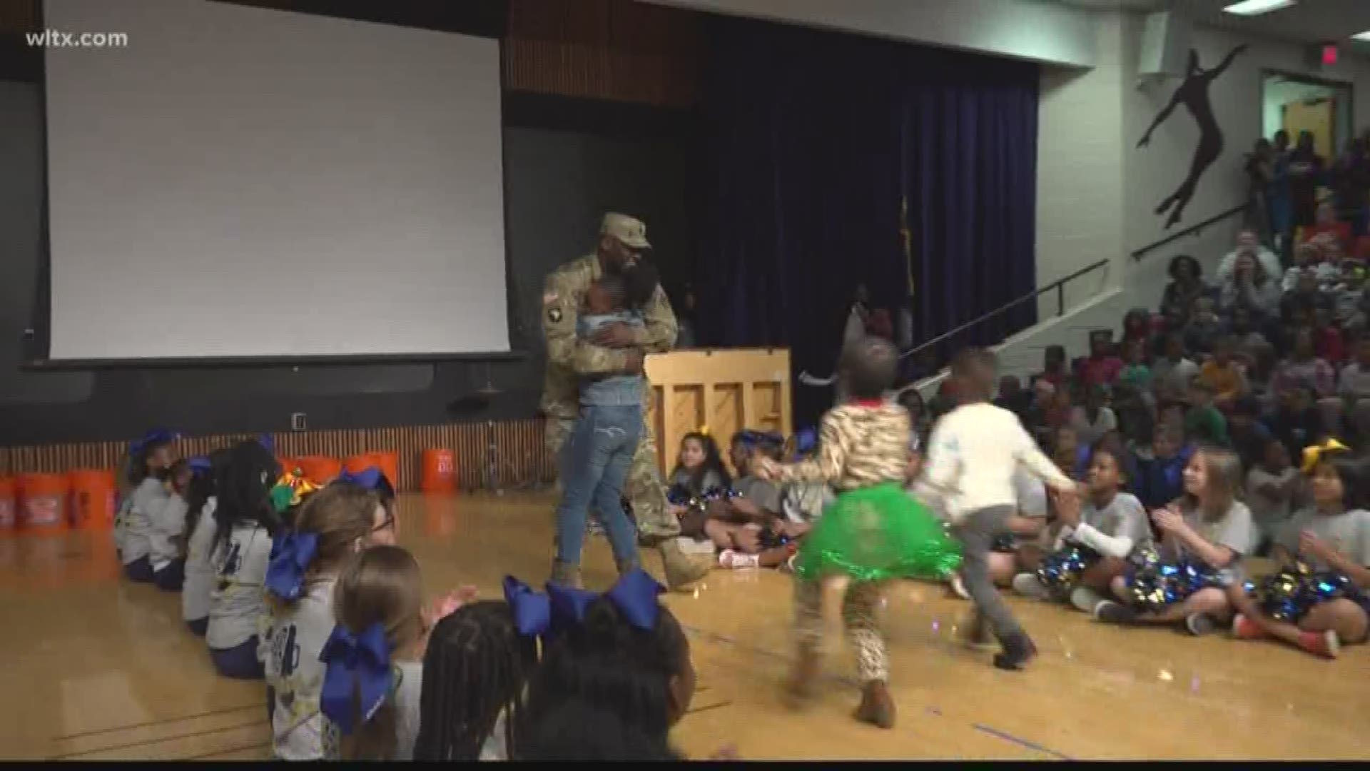 Three Harbison West Elementary kids got a big surprise when their dad came out during their Christmas program.