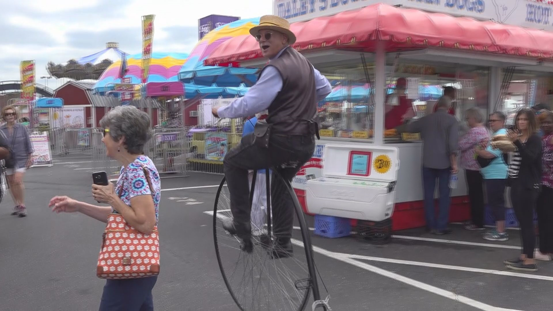 Mr. Dennis rides the old-fashioned penny-farthing bike, a device that came from England to the U.s. in 1869.