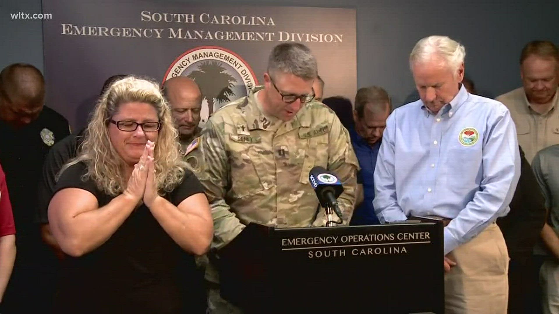 South Carolina officials bowed their heads in prayer before a news conference on their preparations for Hurricane Florence.