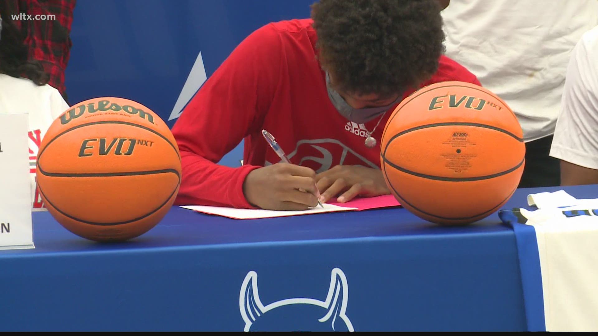 One football player and two basketball players signed their national letters of intent on Wednesday.