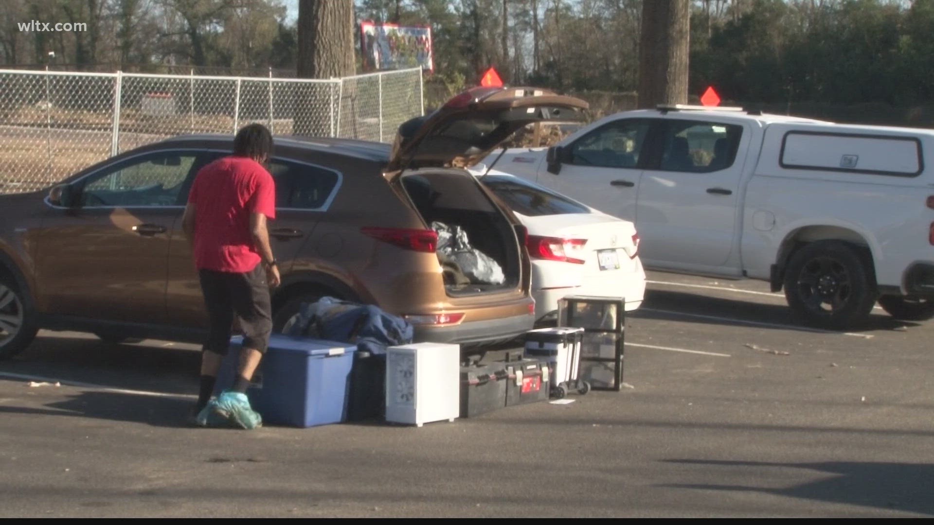 Families went in and out of their scorched homes on Wednesday trying to save as much as they could.