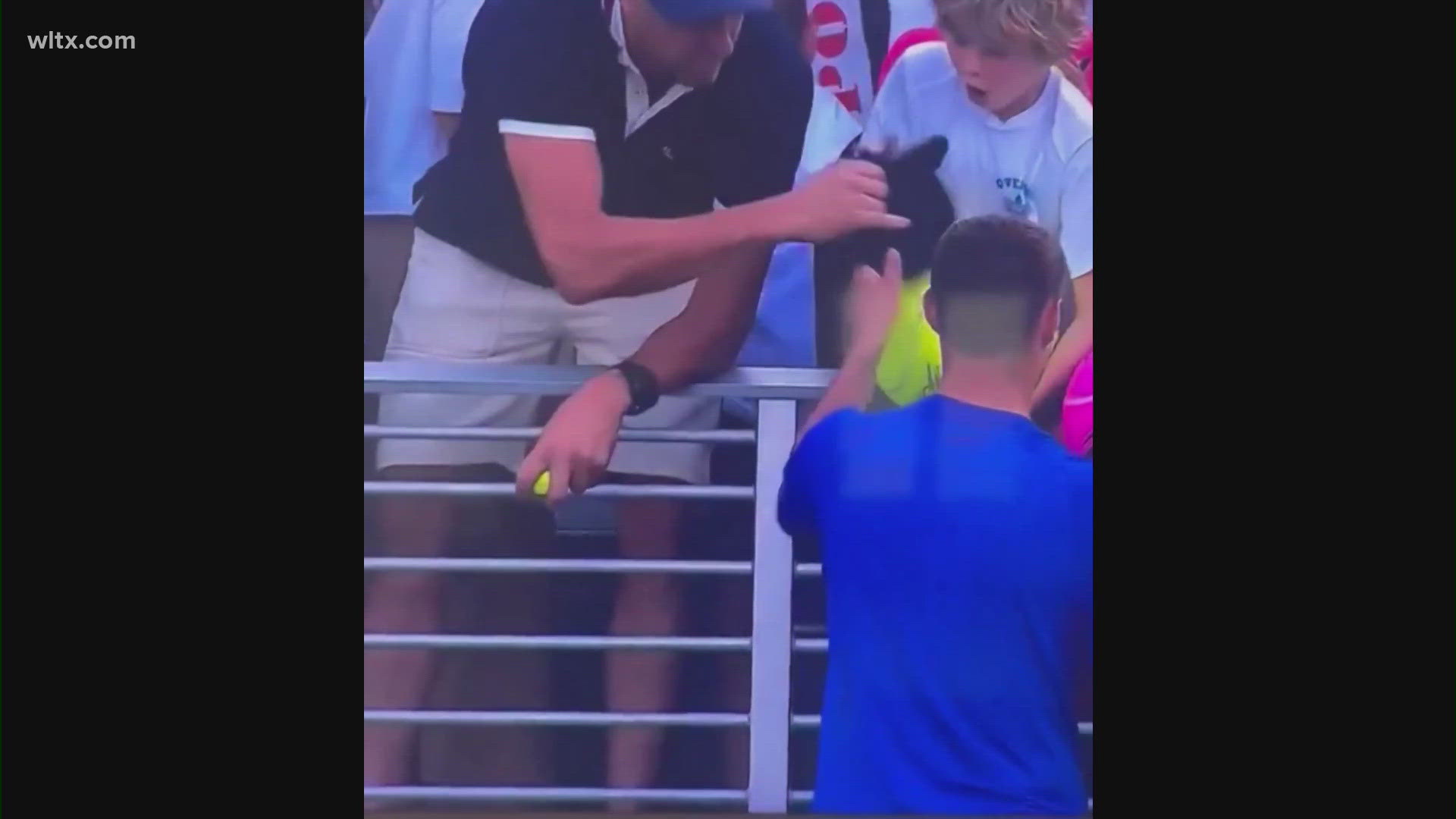 A video of a man taking a hat autographed by a tennis player from a child at the U.S. Open has gone viral.