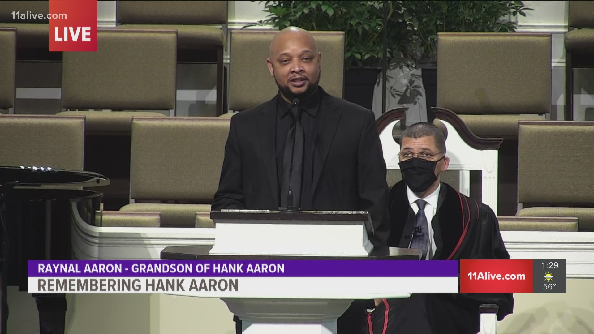 Raynal Aaron reads his favorite quotes by his grandfather during the funeral at Friendship Baptist Church.